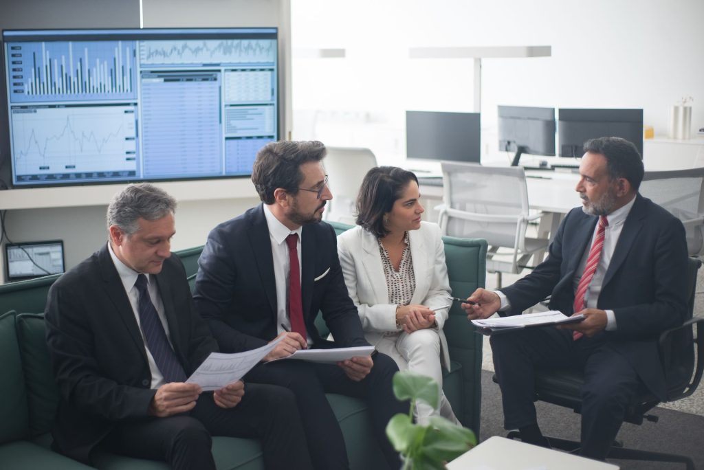 Business owners meeting with financial advisors in a modern office